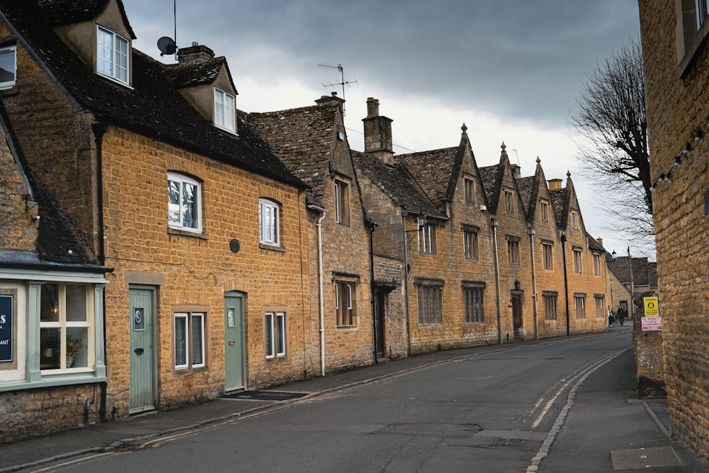 a street lined with brick buildings under a cloudy sky