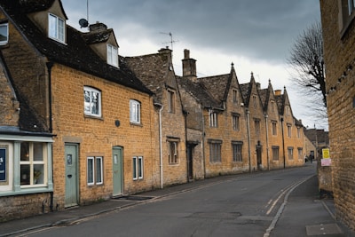 a street lined with brick buildings under a cloudy sky