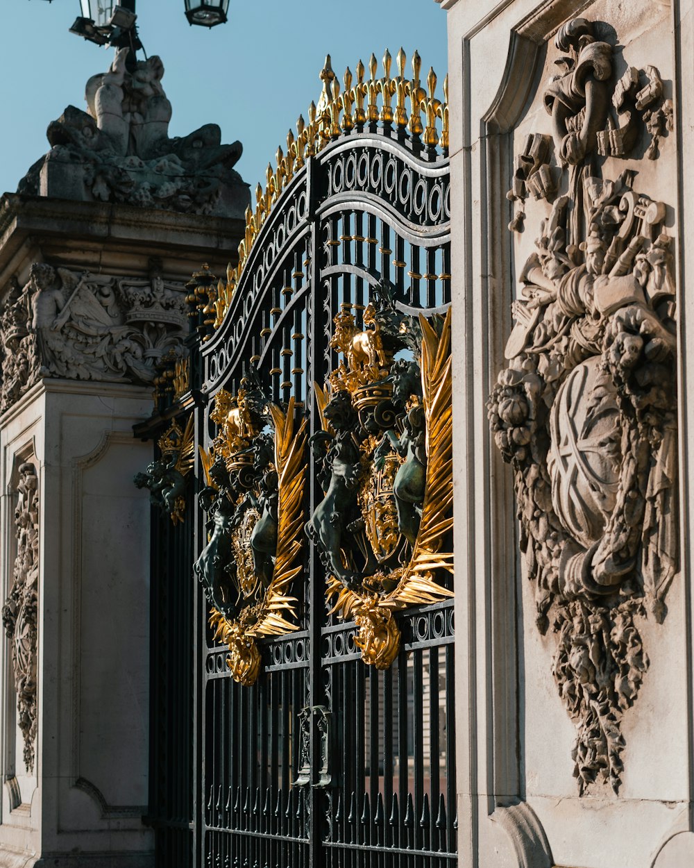 a black gate with gold decorations on it