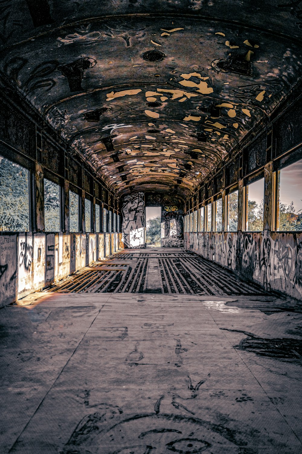 an abandoned train station with graffiti all over the walls