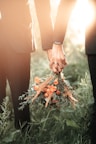 a couple of people holding a bouquet of flowers