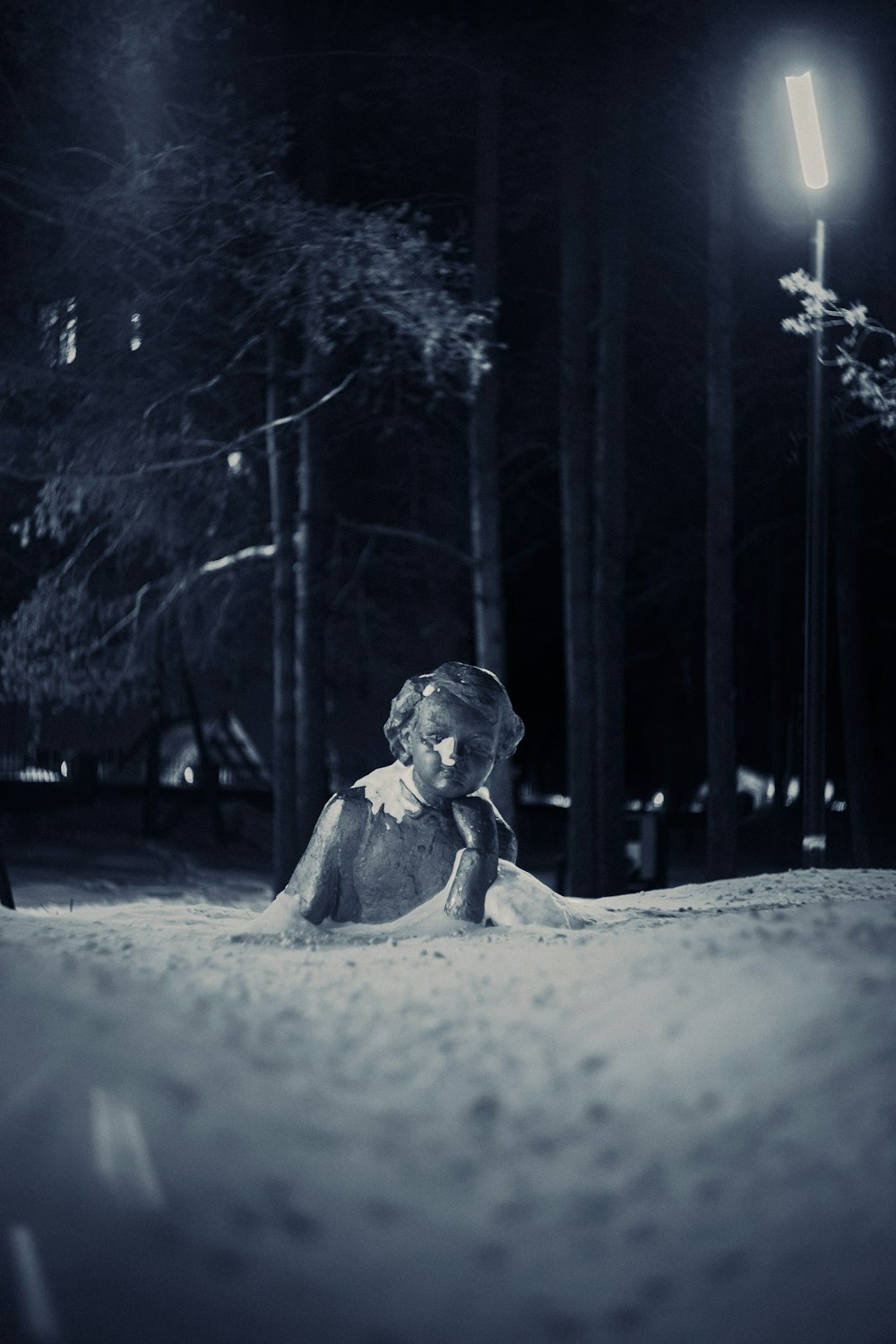 a woman sitting in the snow at night
