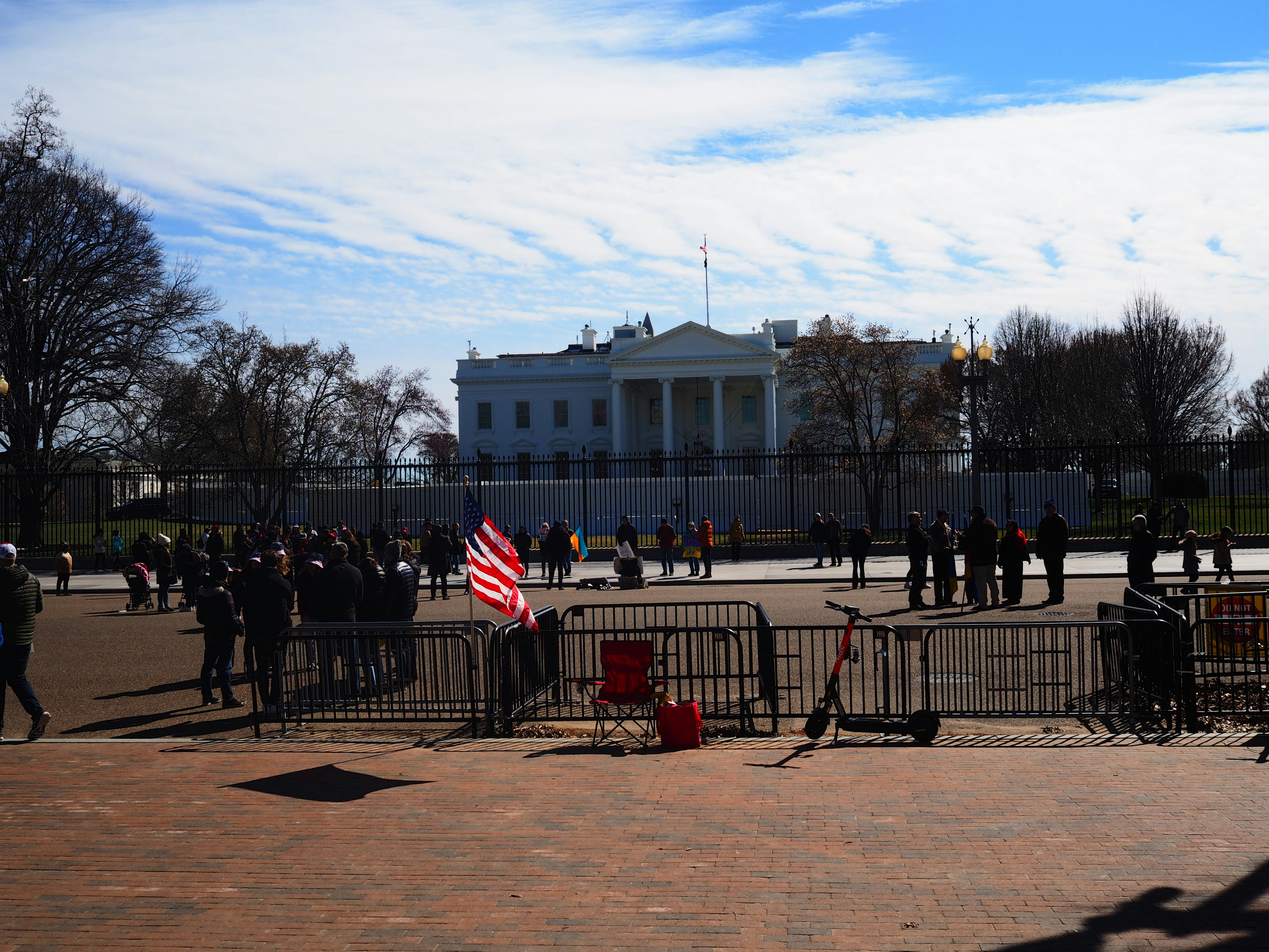 a group of people standing in front of a white house (Photo by Brelyn Alston-Barclay on Unsplash)