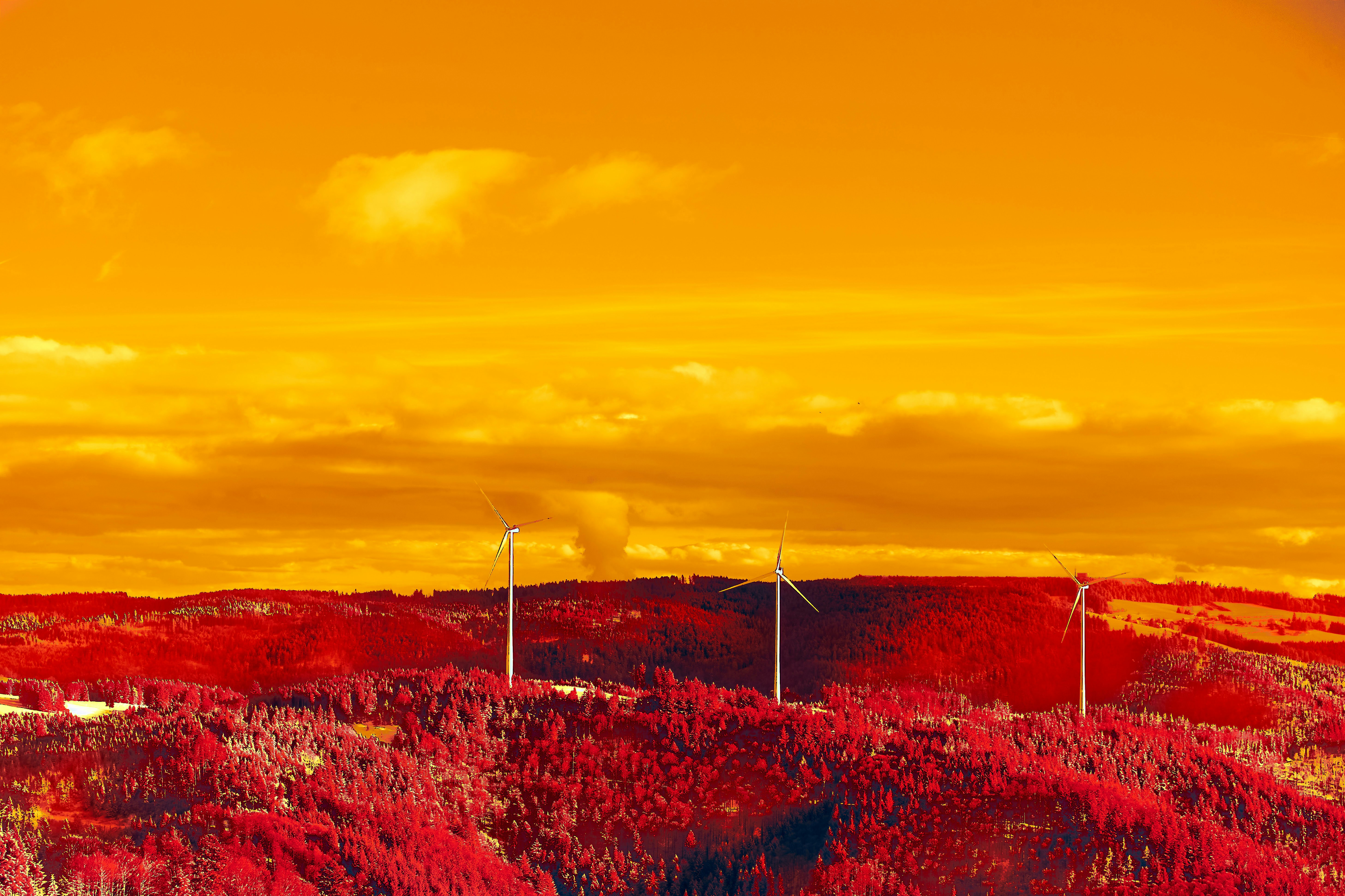 A group of wind turbines on a hill photo – Free Orange Image on Unsplash