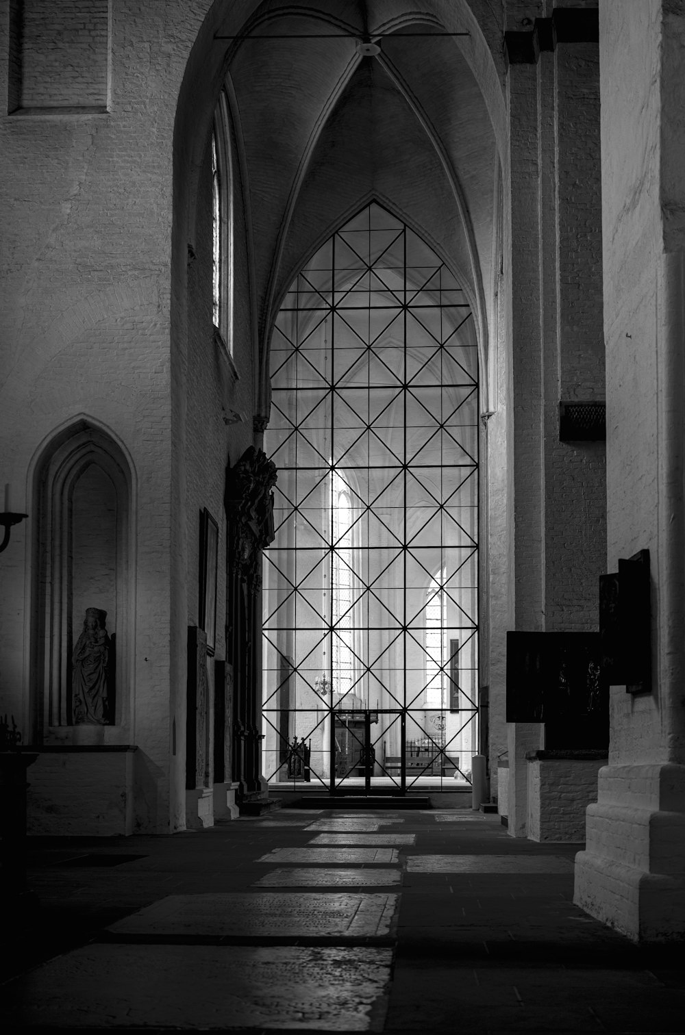 a black and white photo of a church entrance
