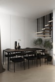 A dining area showcasing a minimalist dining table with elegant chairs.