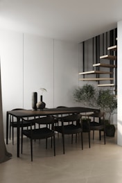 A modern dining area featuring a sleek table and chairs.