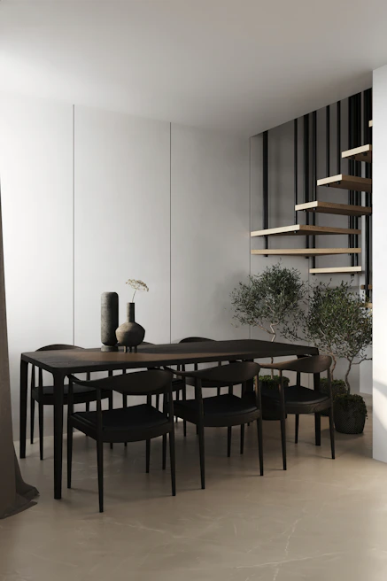 A minimalist dining area showcasing a handcrafted wooden table paired with modern chairs.