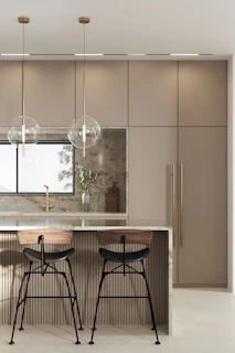 Contemporary kitchen island with acrylic surfaces and golden handles