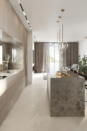 A sleek, modern interior space featuring a modular kitchen with subtle gold accents and clean lines.
