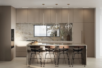 a kitchen with a center island and bar stools