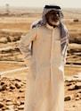 a man standing in the middle of a desert