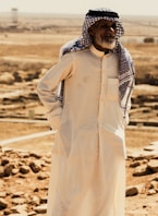 a man standing in the middle of a desert
