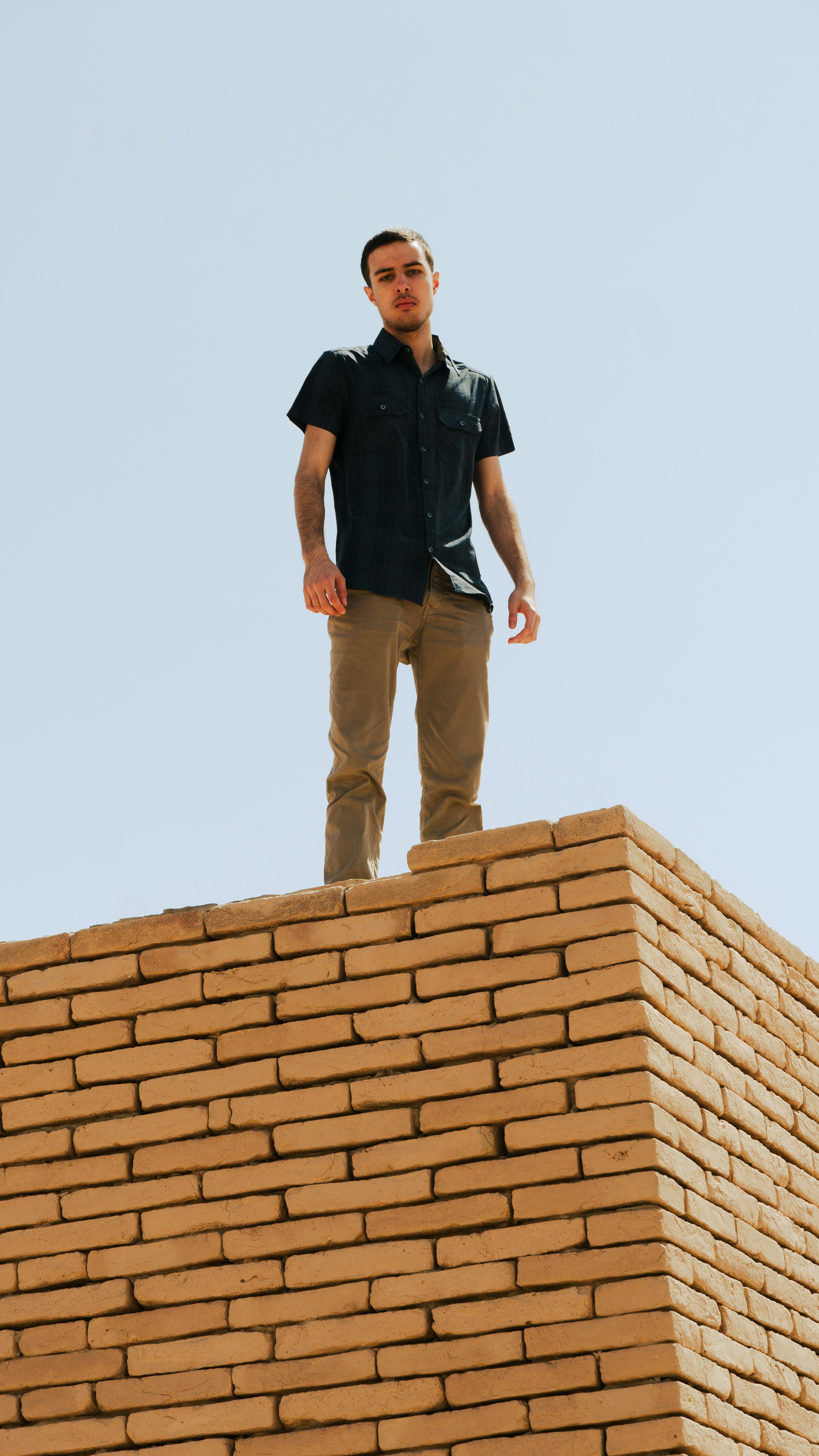 a man standing on top of a brick building