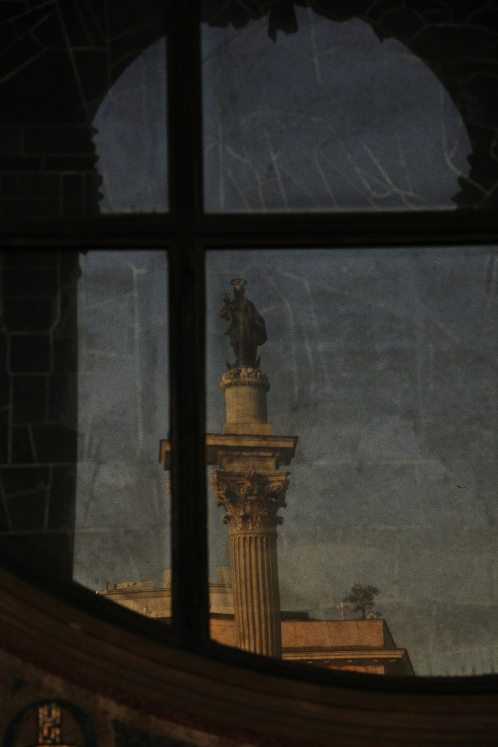 a view of a statue through a window