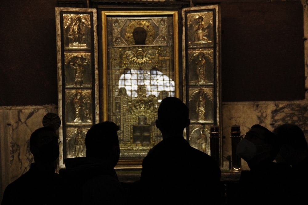 a group of people standing in front of a glass door