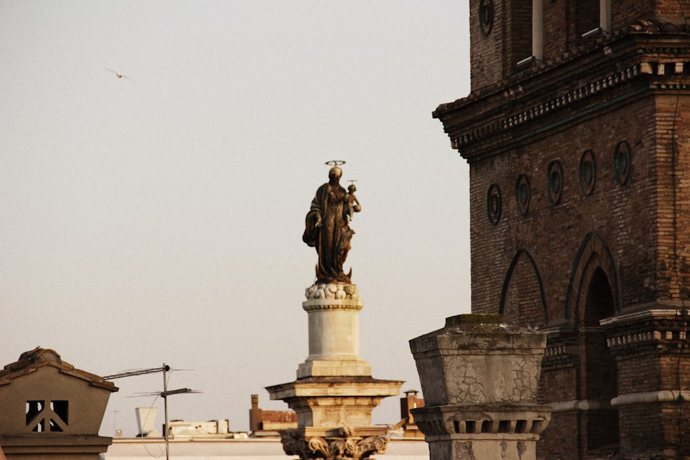 a statue of a man on a horse in front of a building