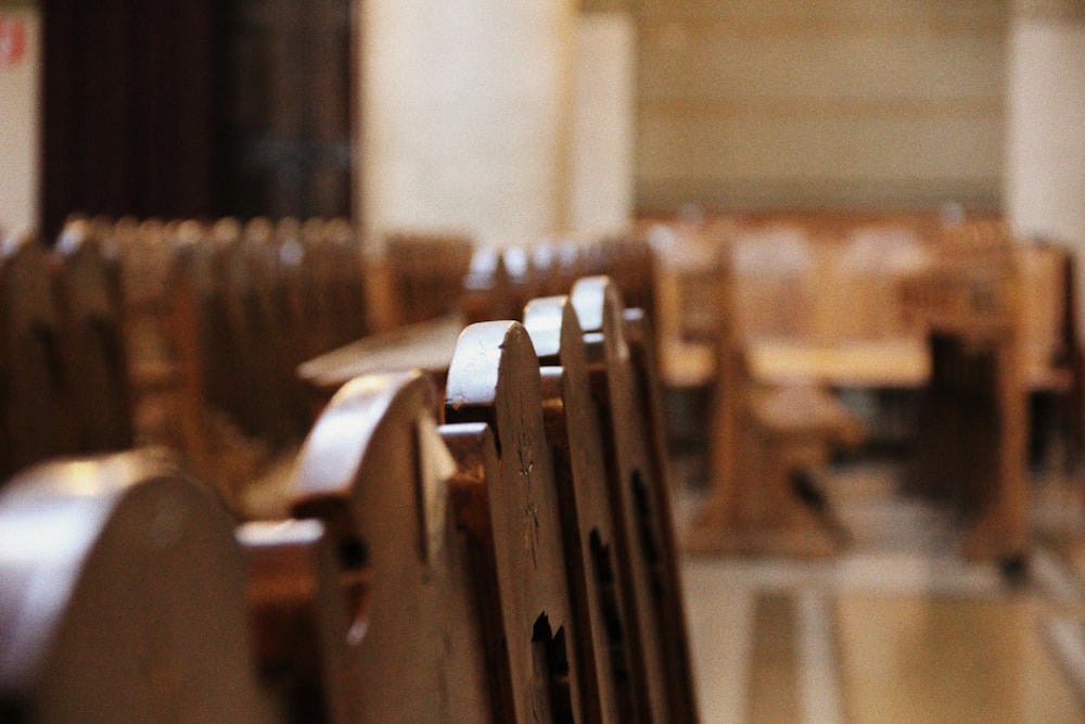 a row of wooden chairs sitting next to each other