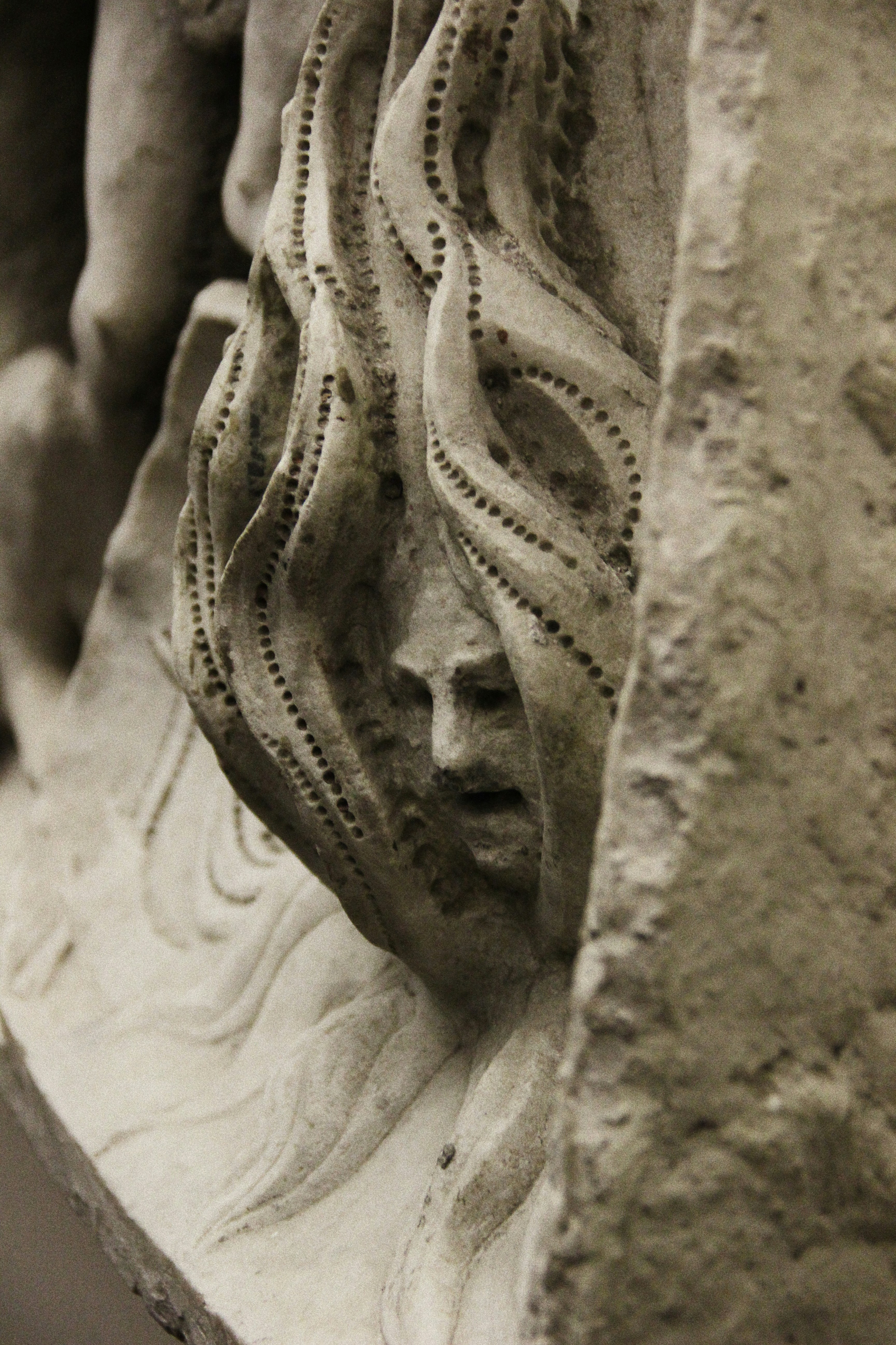 a close up of a statue of a woman's face