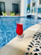 Refreshing drinks served elegantly beside a tranquil spa pool area.