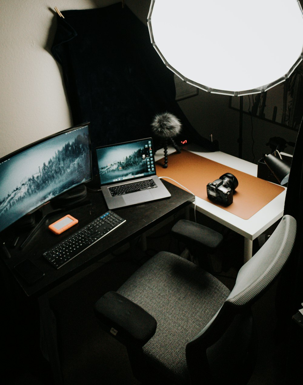 a laptop computer sitting on top of a wooden desk