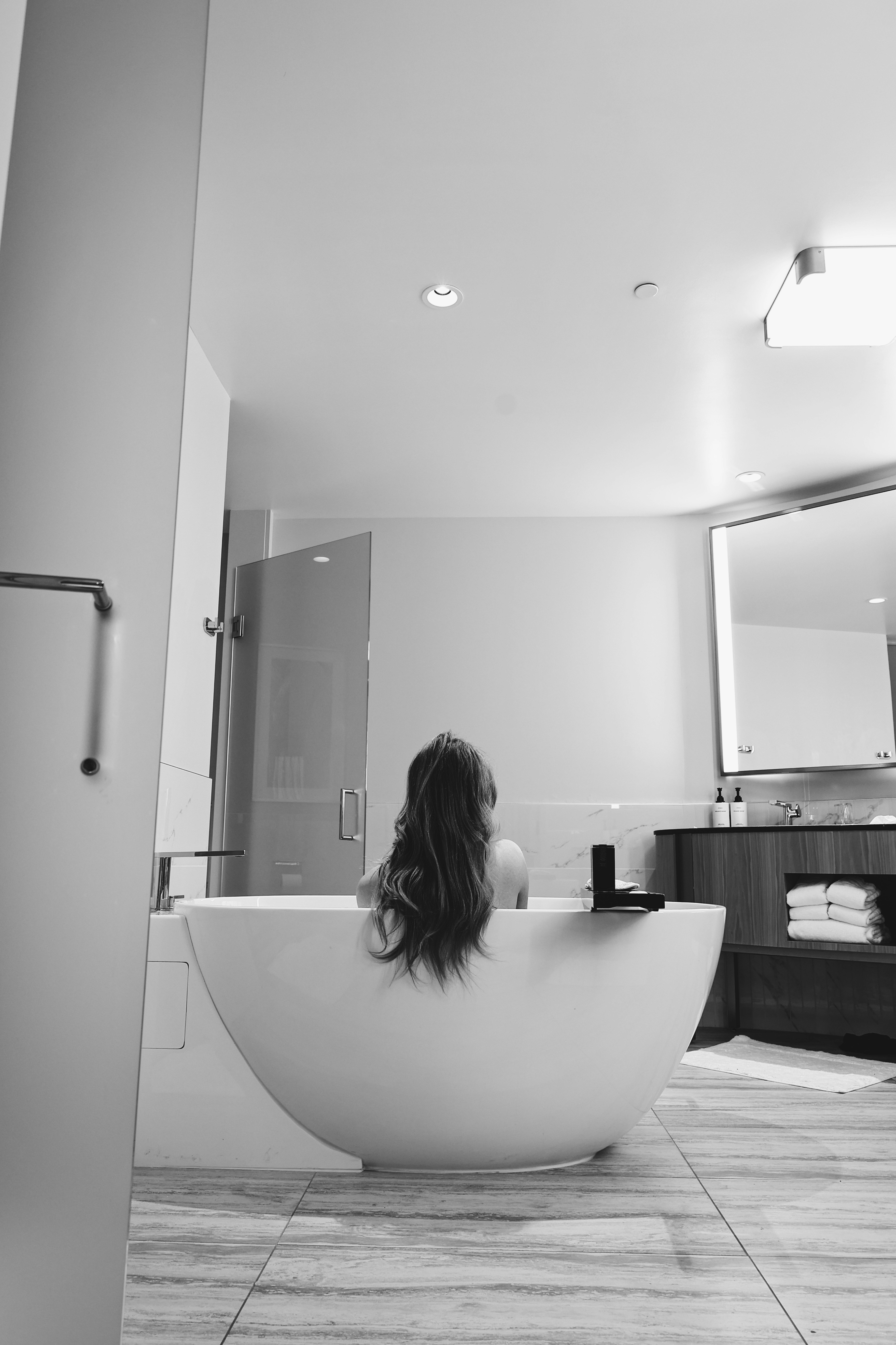 a woman sitting in a bathtub in a bathroom