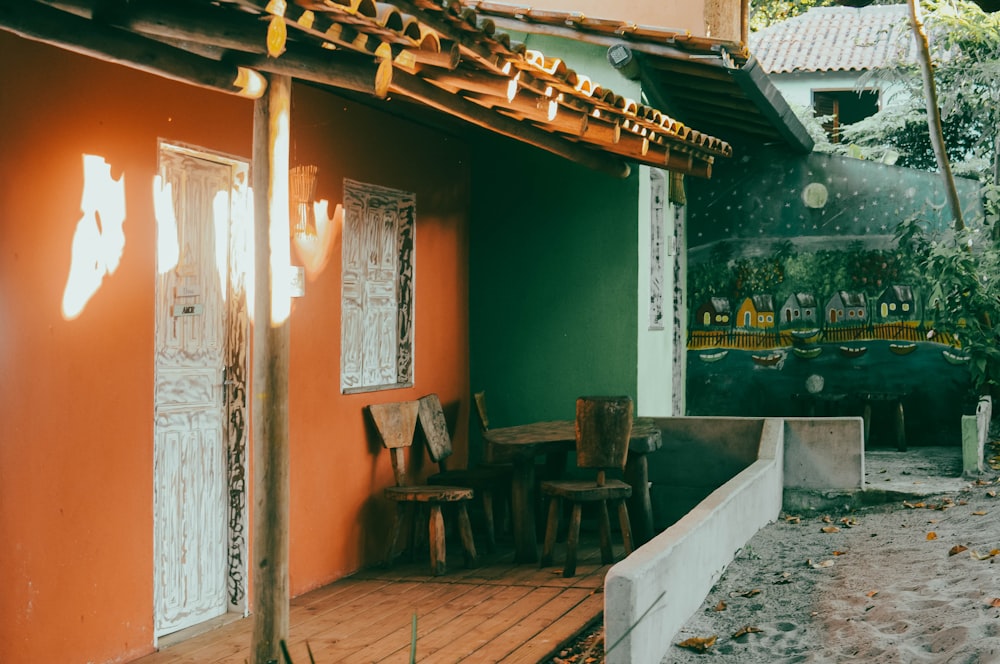 a wooden porch with chairs and a table