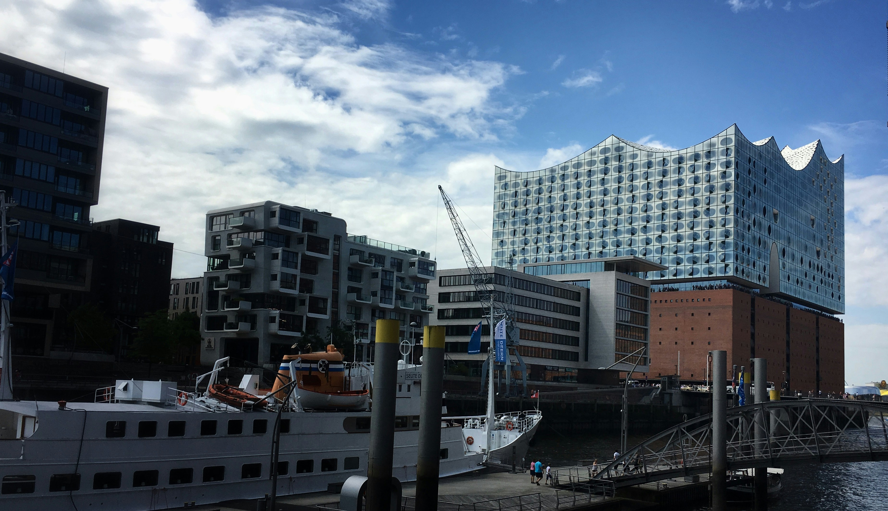 a boat docked in a harbor next to tall buildings