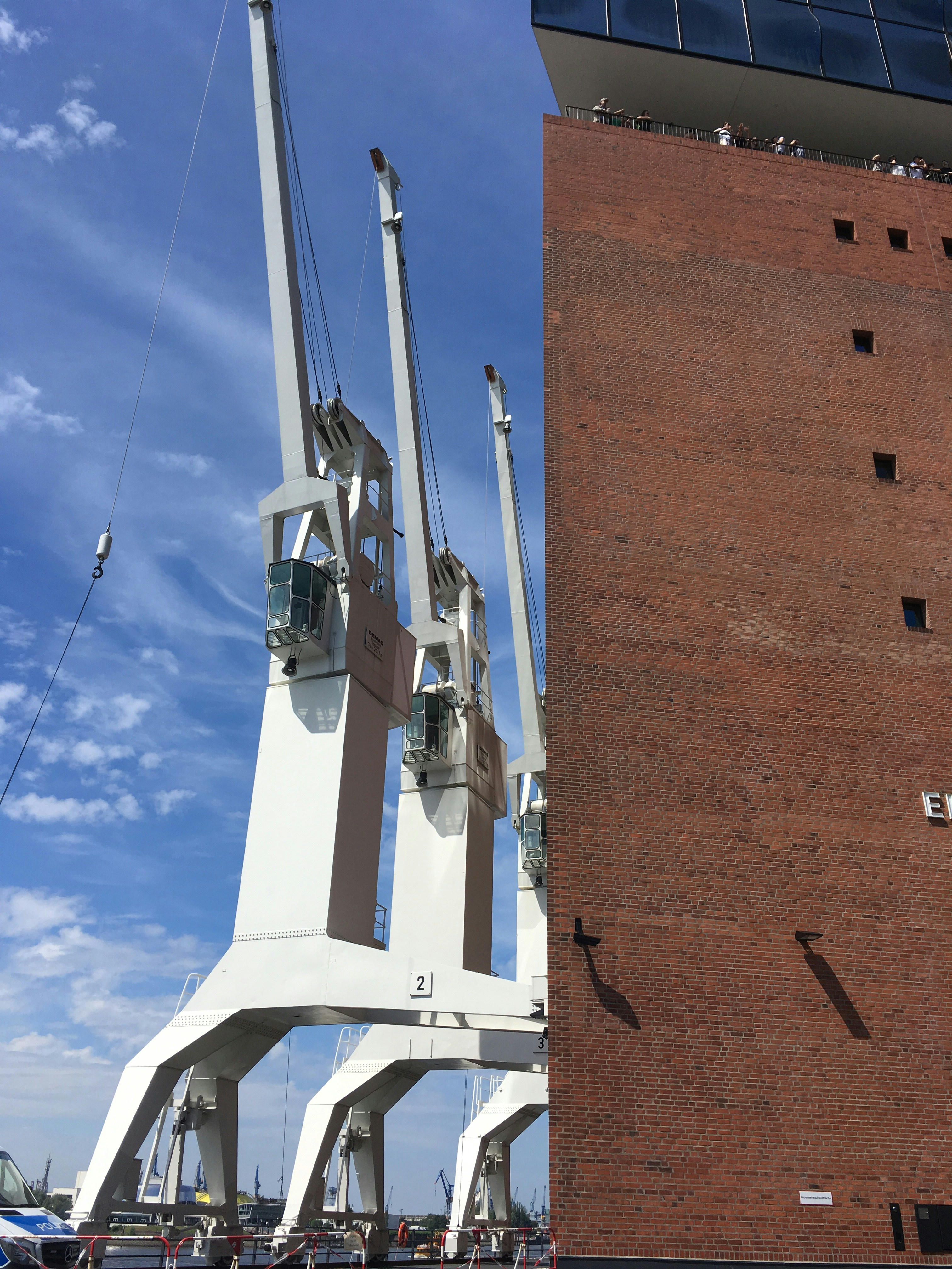 a tall white structure next to a tall brick building