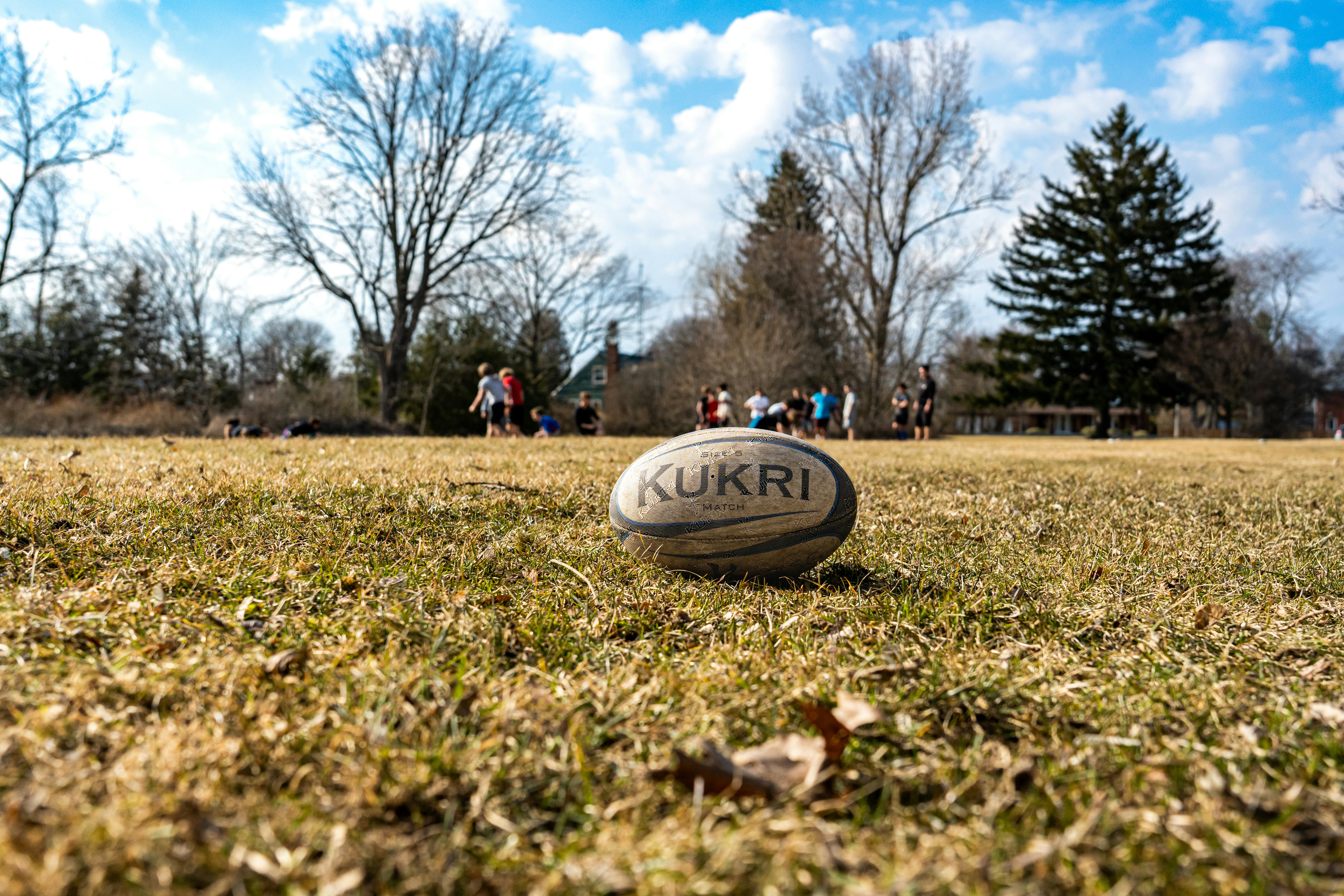 a rugby ball in the foreground of a practice