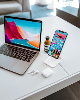 a laptop computer sitting on top of a white table