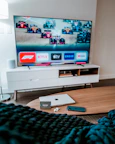 a flat screen tv sitting on top of a wooden table