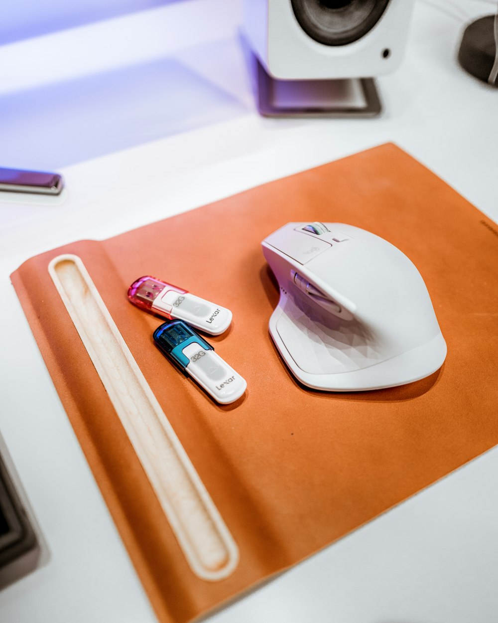 a mouse pad, keyboard, and two batteries on a desk