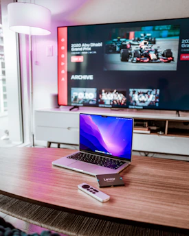 a laptop computer sitting on top of a wooden desk