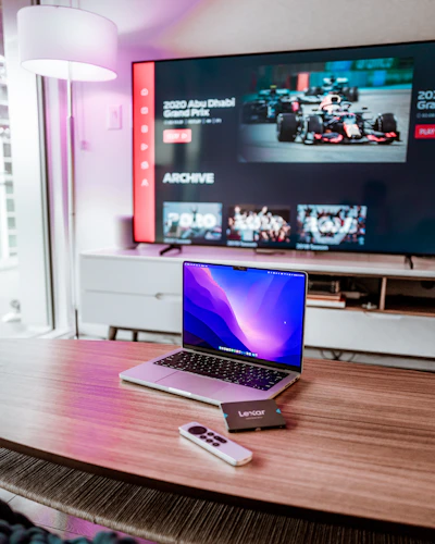 a laptop computer sitting on top of a wooden desk