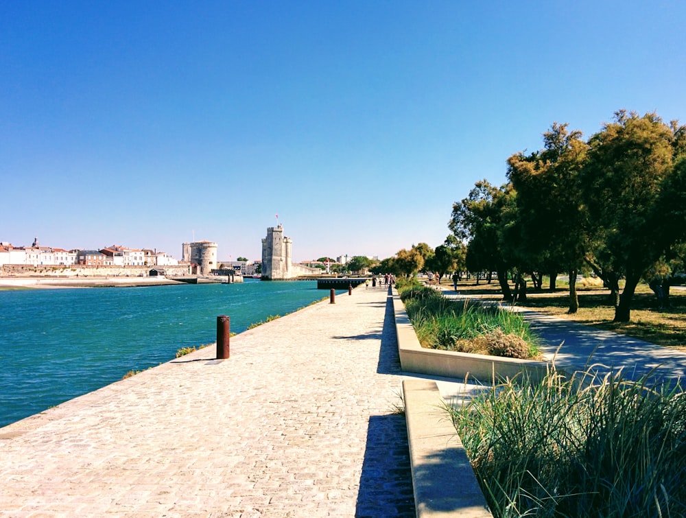 a walkway next to a body of water