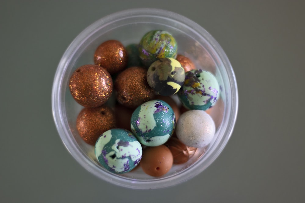 a plastic container filled with lots of different colored eggs