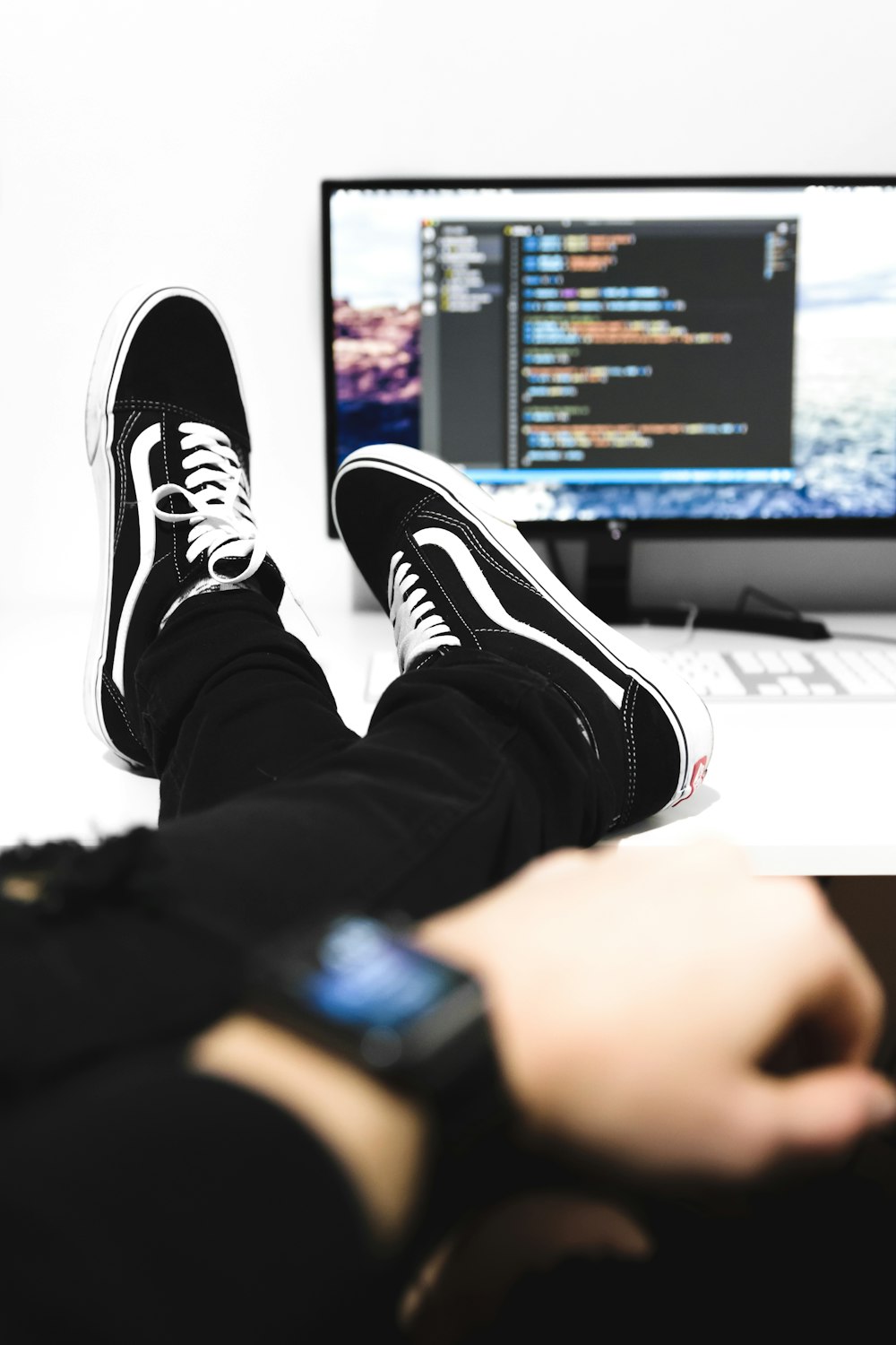 a person sitting in front of a computer monitor