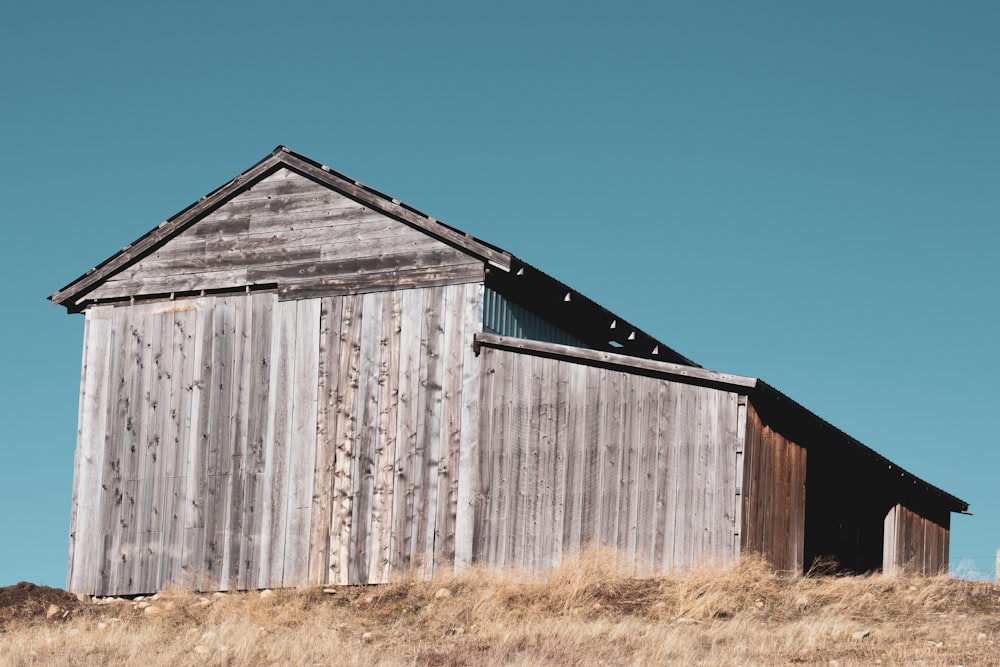 an old wooden building sitting on top of a hill