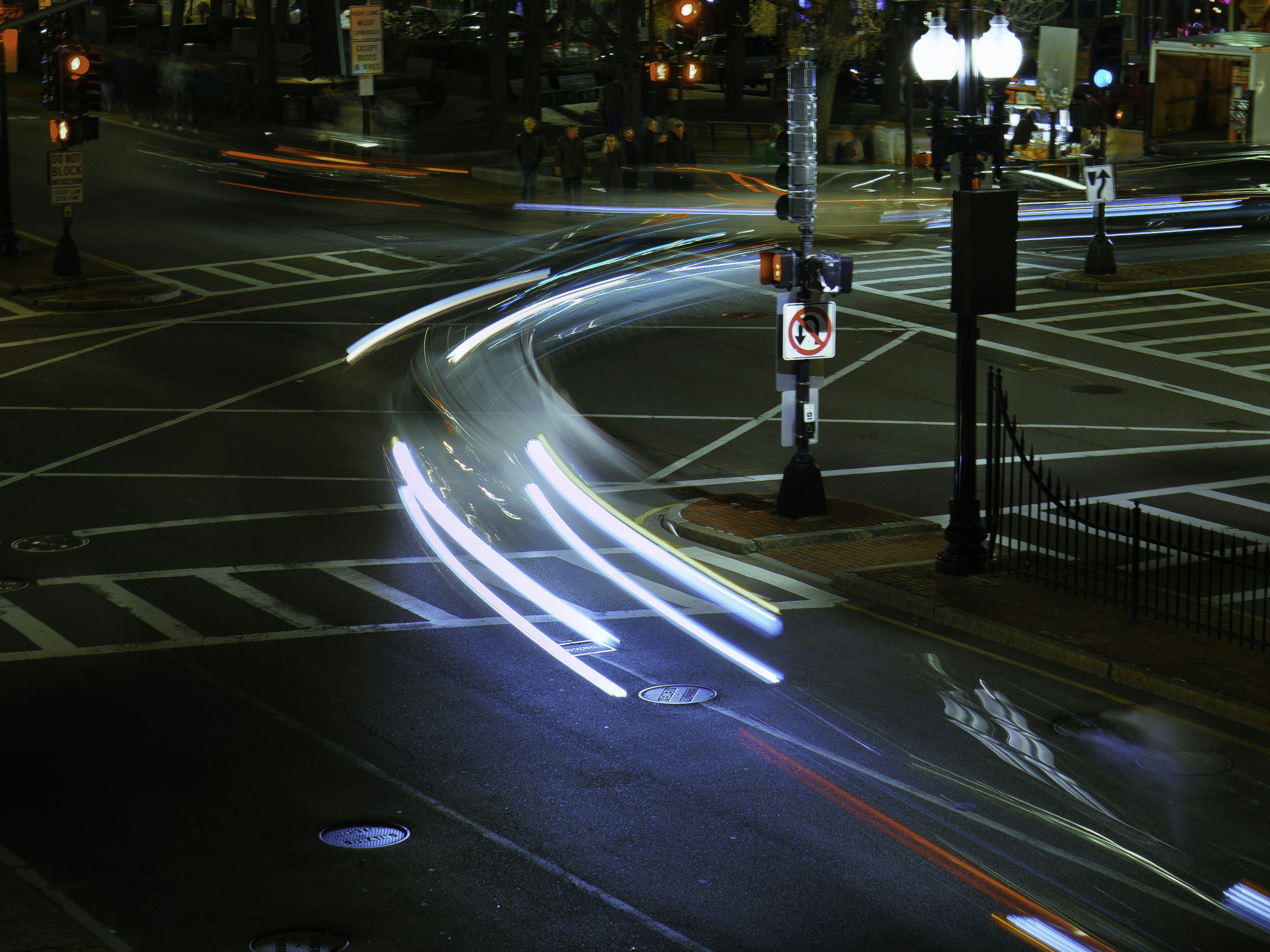 Electric car driving in city traffic approaching a red light, where regenerative braking is most effective.