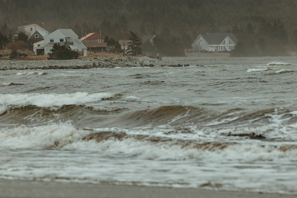 a view of a beach with houses in the background