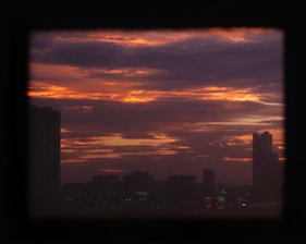 Downtown Los Angeles skyline at dusk with dark purple hues.