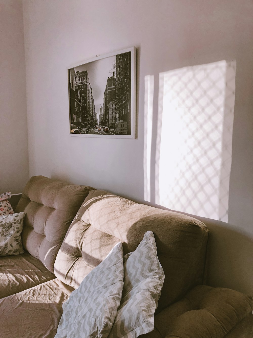 a living room with a couch and a picture on the wall