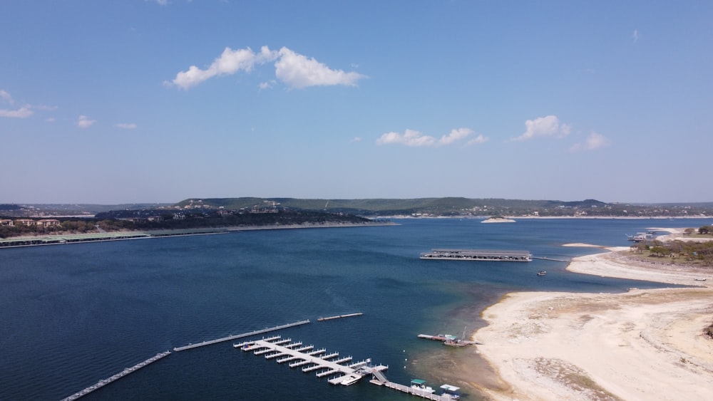 a large body of water surrounded by a sandy beach