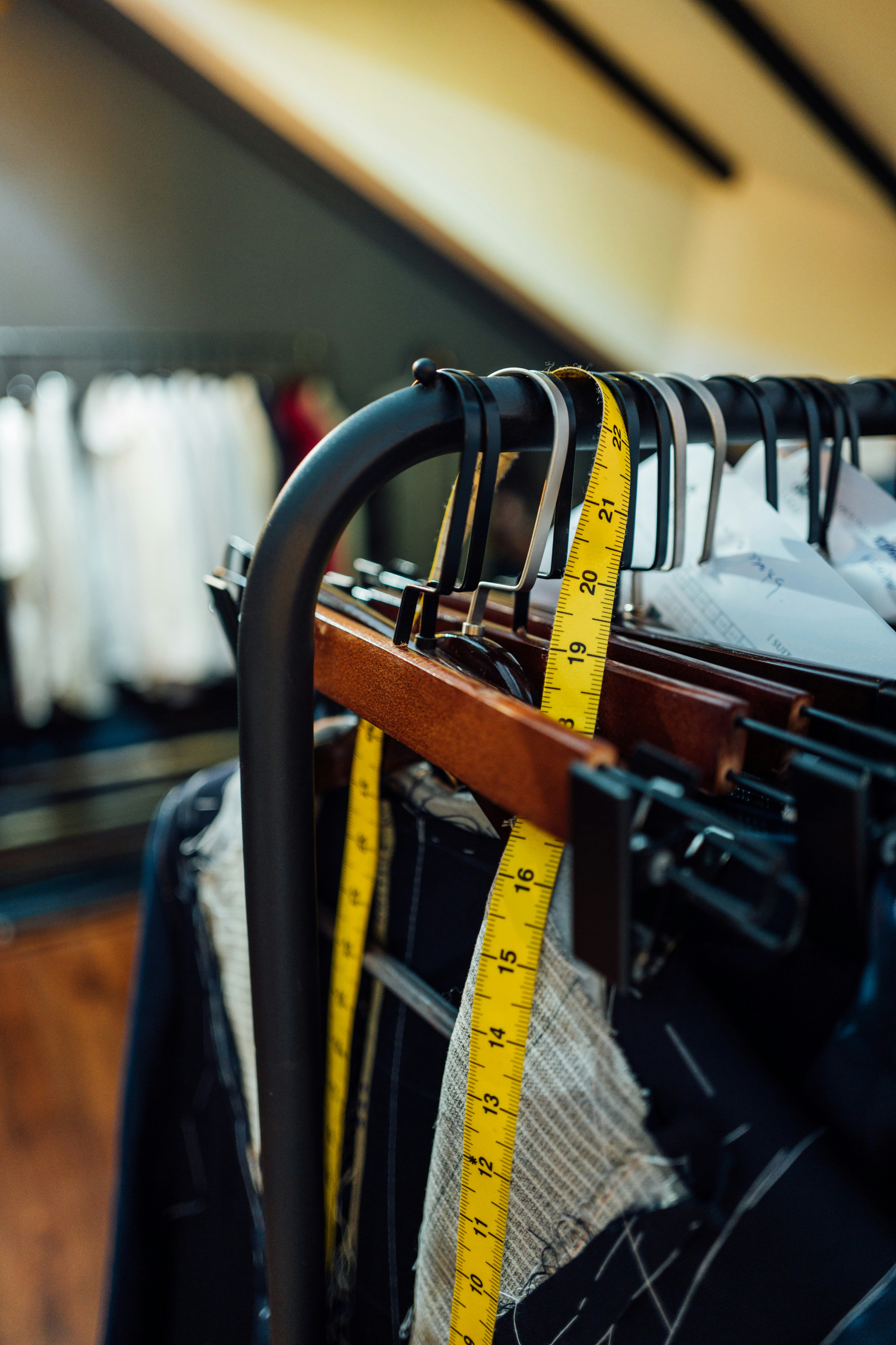 a rack of clothes with a measuring tape on it