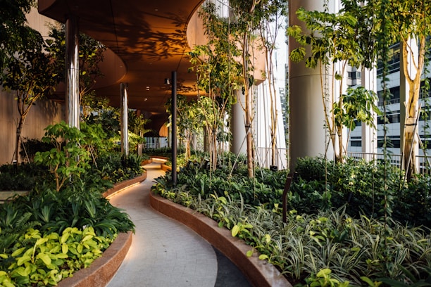Lush landscaped garden paths lined with tropical plants and seating areas in the Lodha Sylvan community.