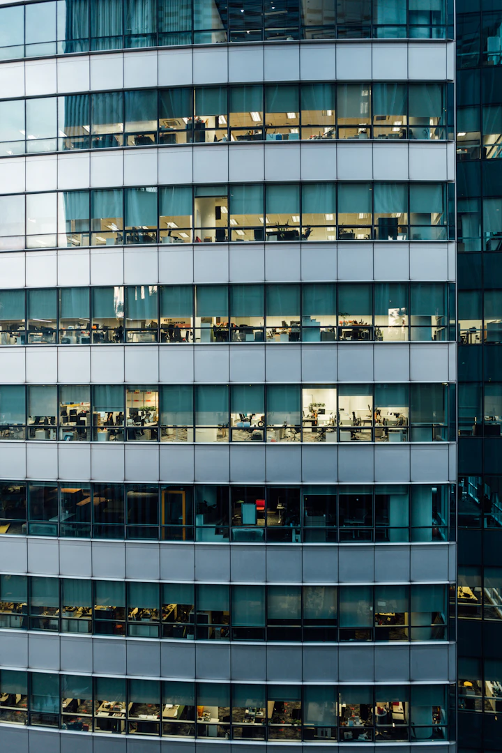 Modern office building with illuminated workspaces