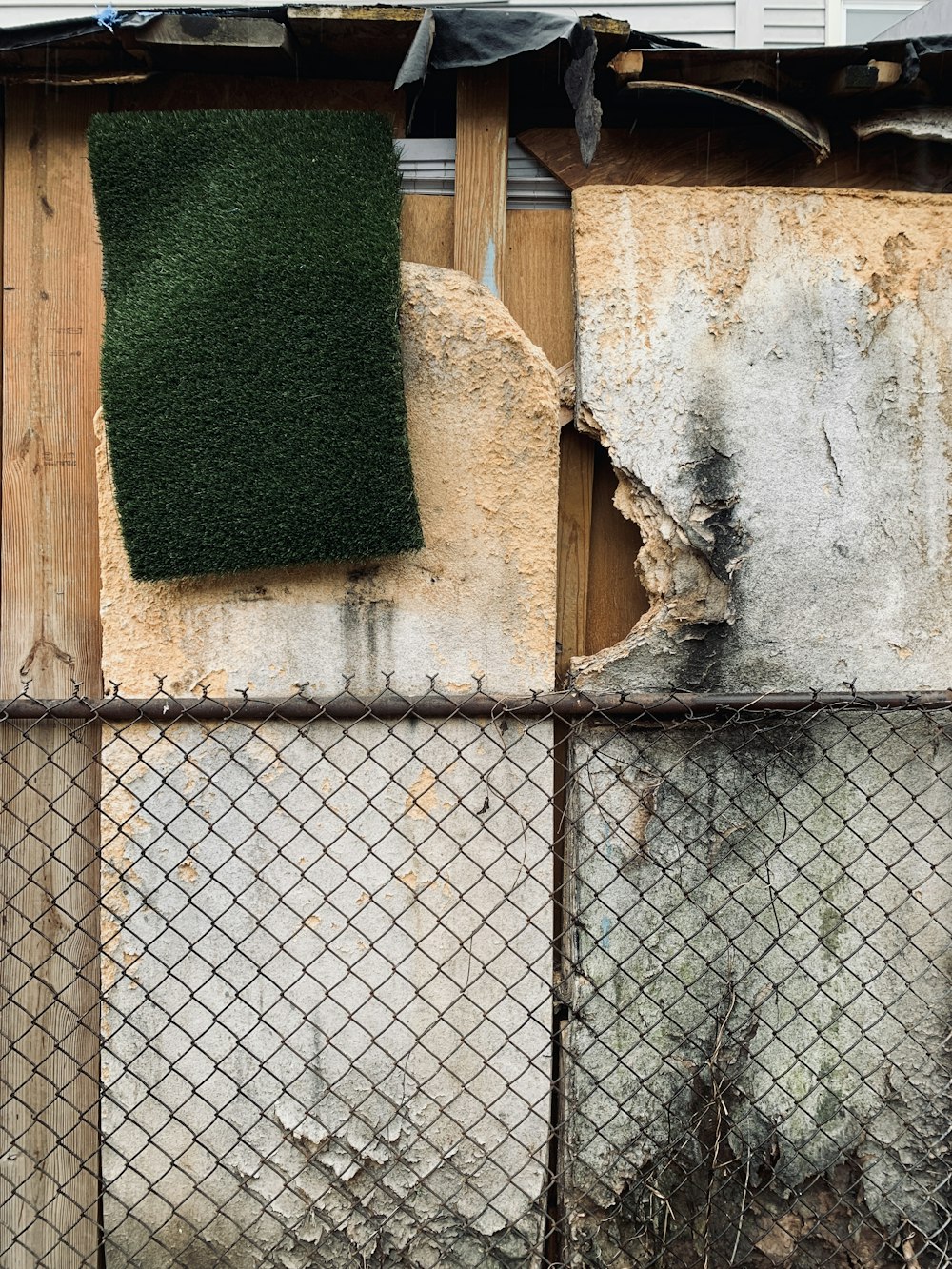 a fence with a piece of grass on top of it