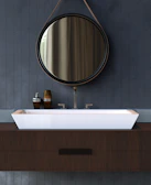Contemporary bathroom vanity with porcelain finishes and custom mirror installation.
