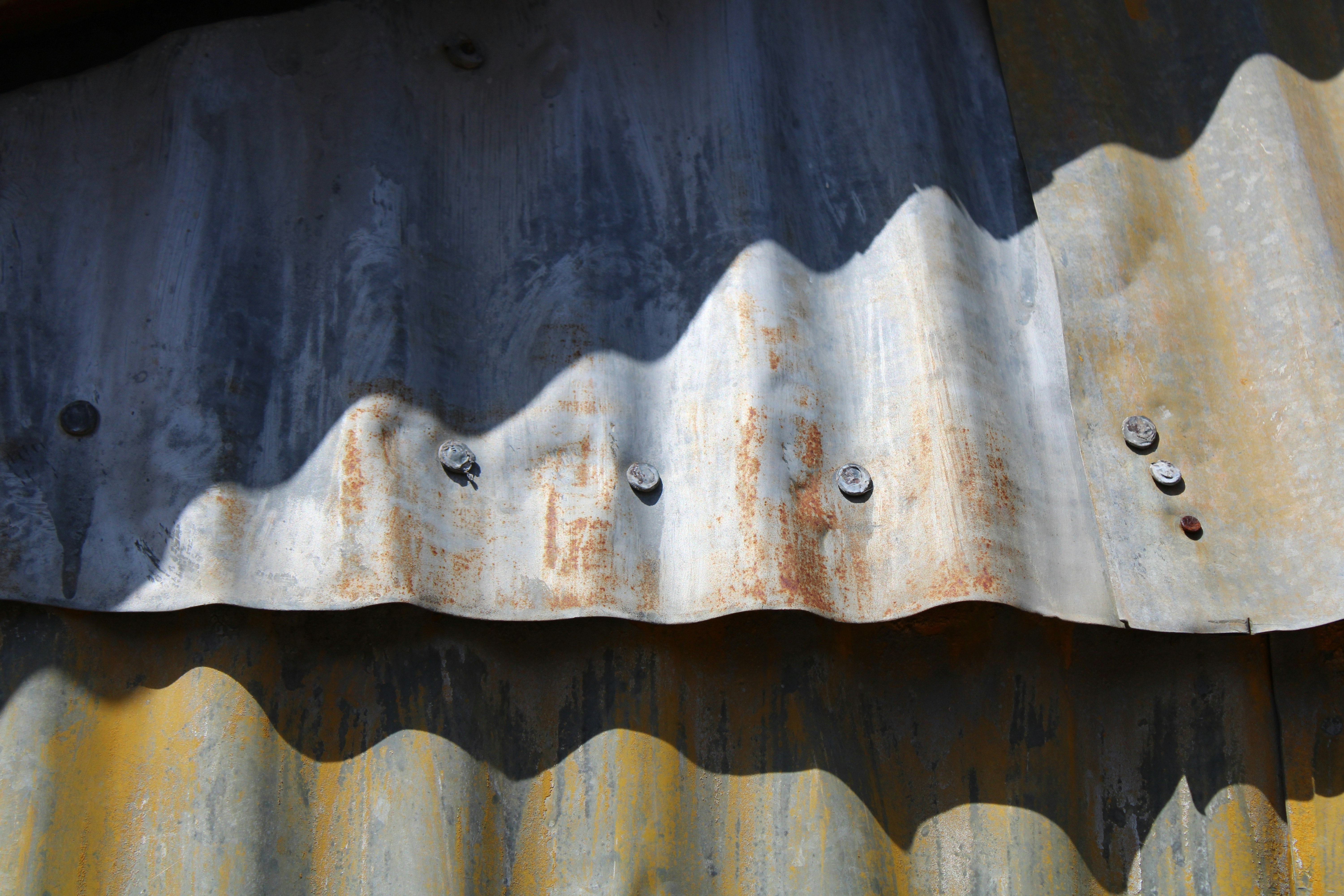 a rusted metal roof with holes in it